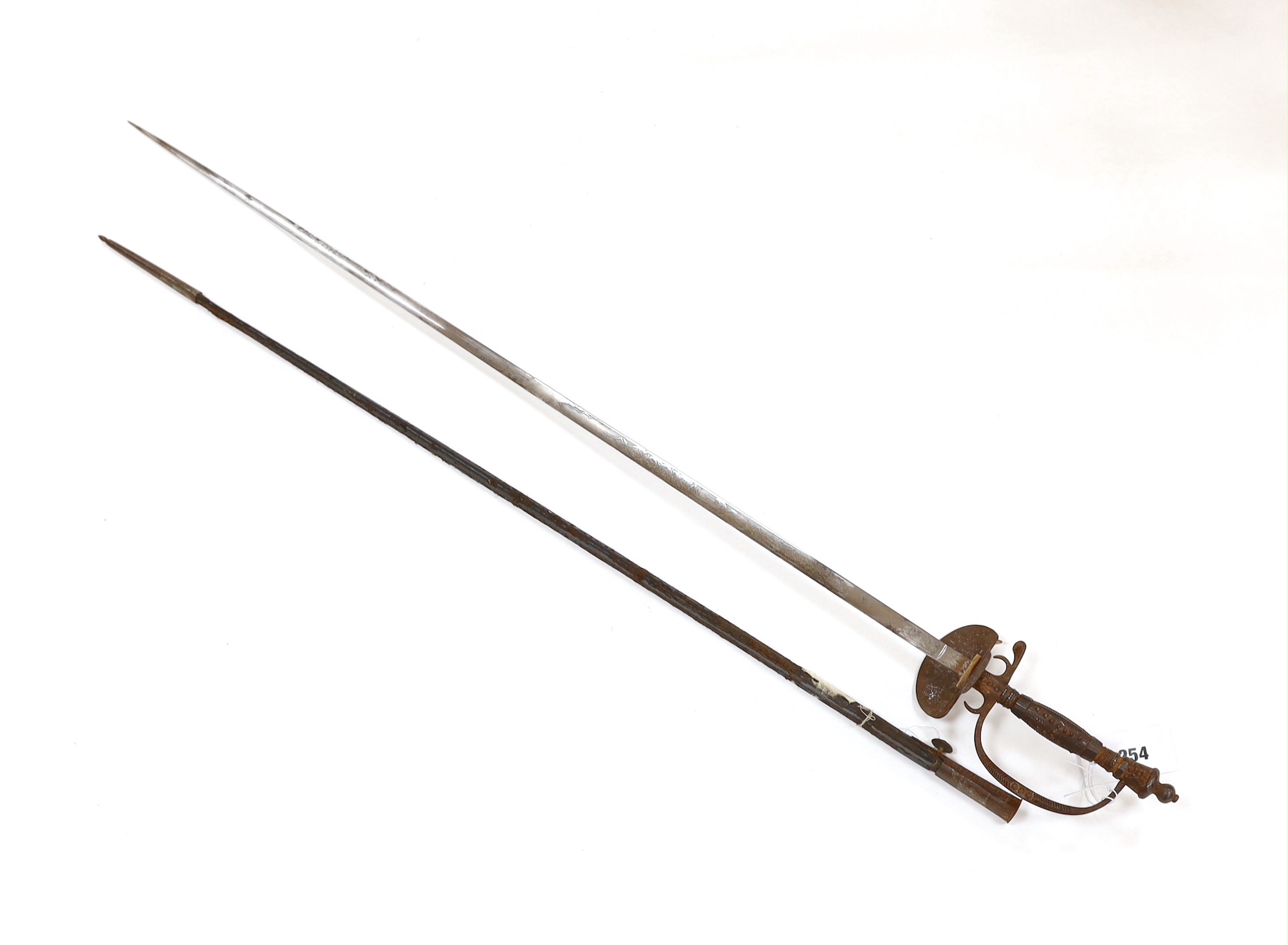 An English cut steel hilted dress court sword, c.1900, polished blade etched at forte, iron hilt slightly rusted, in its leather scabbard, blade 79cm
